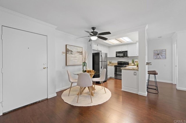 kitchen with ceiling fan, ornamental molding, appliances with stainless steel finishes, dark wood-style floors, and white cabinets