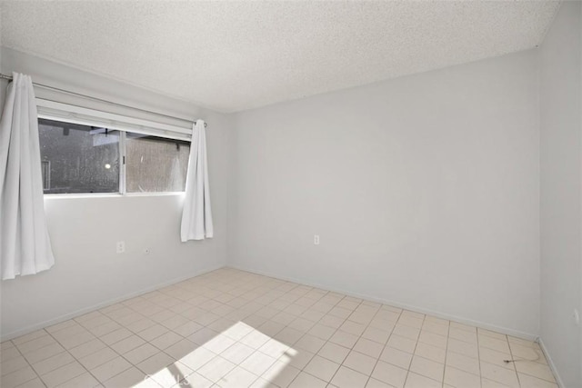2405 Via Mariposa W Unit 2G, Laguna Woods, CA 92637 - empty room with a textured ceiling and tile patterned flooring