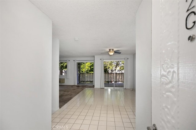 2405 Via Mariposa W Unit 2G, Laguna Woods, CA 92637 - corridor featuring light tile patterned flooring and a textured ceiling