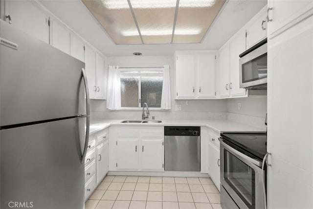 2405 Via Mariposa W Unit 2G, Laguna Woods, CA 92637 - kitchen with appliances with stainless steel finishes, light tile patterned floors, light countertops, and white cabinetry