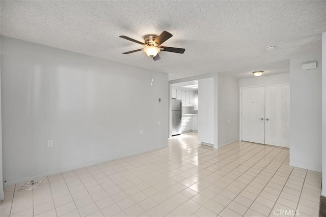 2405 Via Mariposa W Unit 2G, Laguna Woods, CA 92637 - unfurnished room with a ceiling fan, a textured ceiling, light tile patterned floors, and a smoke detector