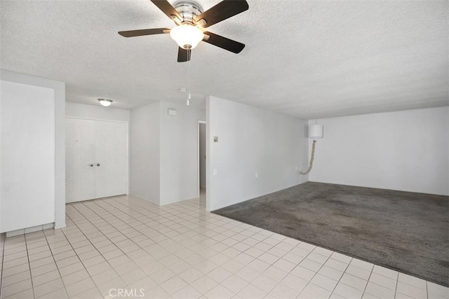 2405 Via Mariposa W Unit 2G, Laguna Woods, CA 92637 - unfurnished room with a textured ceiling, a ceiling fan, light colored carpet, and light tile patterned floors