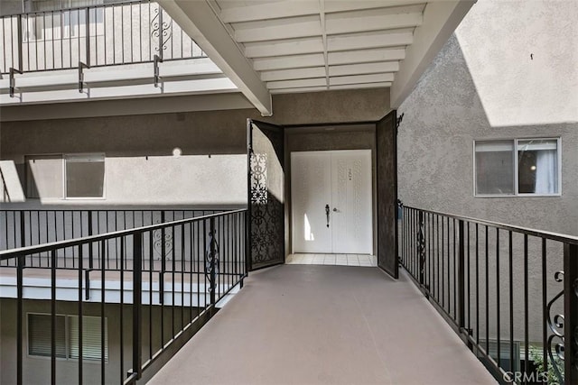 2405 Via Mariposa W Unit 2G, Laguna Woods, CA 92637 - doorway to property featuring a balcony and stucco siding