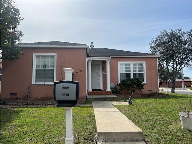 view of front of property with stucco siding and a front yard