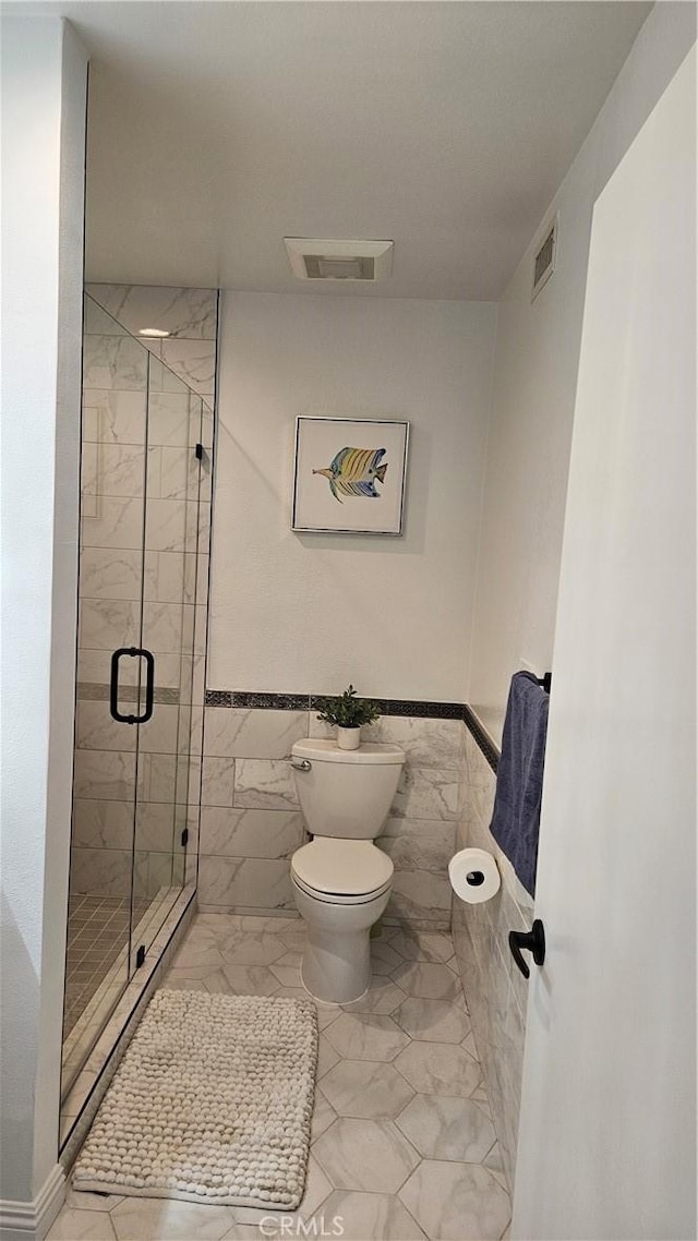 8166 Laguna Ct, Stanton, CA 90680 - bathroom with visible vents, toilet, tile walls, a shower stall, and marble finish floor
