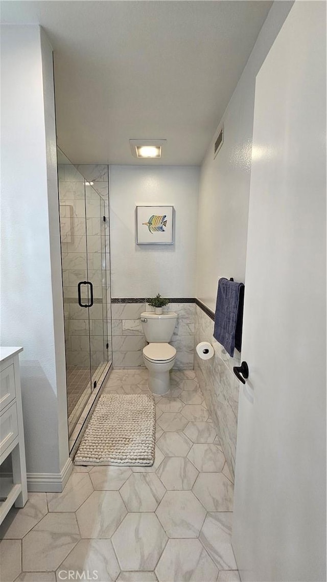 8166 Laguna Ct, Stanton, CA 90680 - full bathroom with vanity, a stall shower, toilet, visible vents, and tile walls
