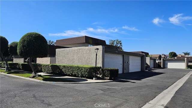 8166 Laguna Ct, Stanton, CA 90680 - view of side of property featuring community garages and stucco siding