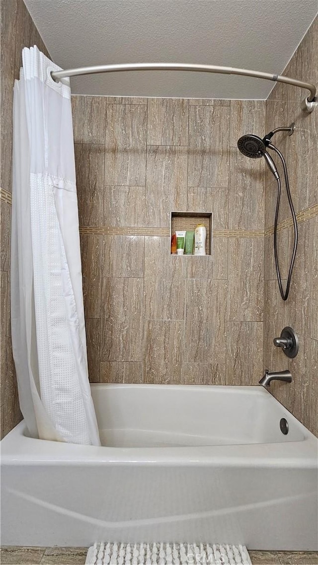 8166 Laguna Ct, Stanton, CA 90680 - full bathroom featuring shower / bathtub combination with curtain and a textured ceiling
