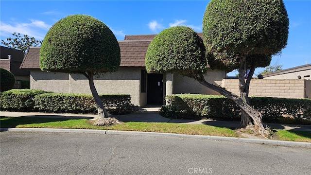 8166 Laguna Ct, Stanton, CA 90680 - view of front of home with roof with shingles, mansard roof, and stucco siding