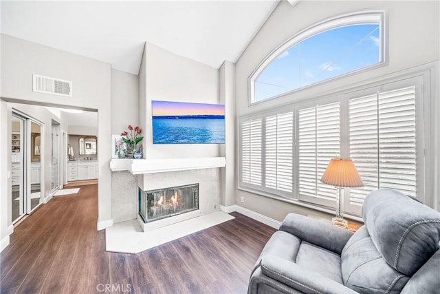 22432 Rosebriar, Mission Viejo, CA 92692 - living area featuring wood finished floors, vaulted ceiling, and a premium fireplace