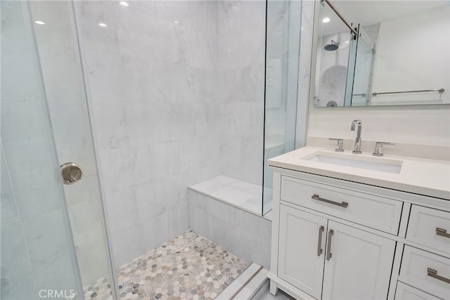 bathroom featuring a stall shower and vanity