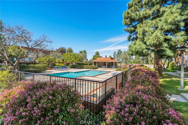 community pool featuring a patio and fence