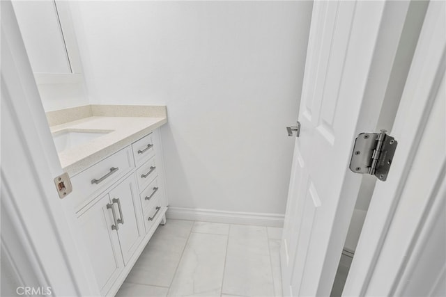 bathroom with vanity and baseboards