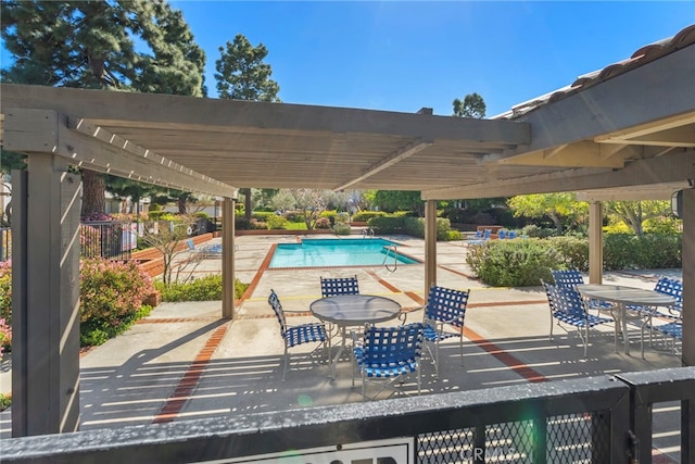 community pool featuring outdoor dining space, a patio area, and a pergola