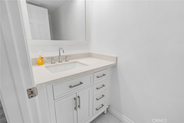 bathroom featuring vanity and baseboards