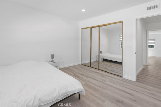 bedroom featuring recessed lighting, wood finished floors, visible vents, and baseboards