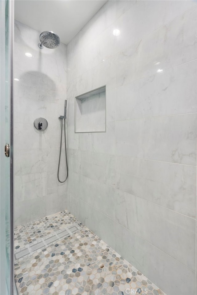 bathroom with tiled shower