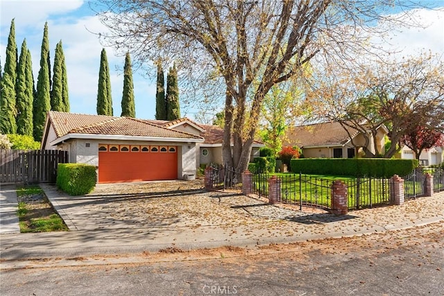 single story home with a fenced front yard, an attached garage, a tile roof, stucco siding, and driveway