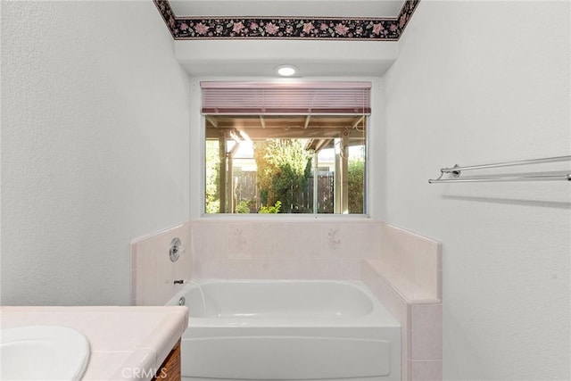 full bath with a bath and vanity
