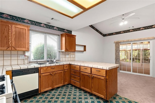 kitchen featuring plenty of natural light, white dishwasher, ceiling fan, a peninsula, and stove