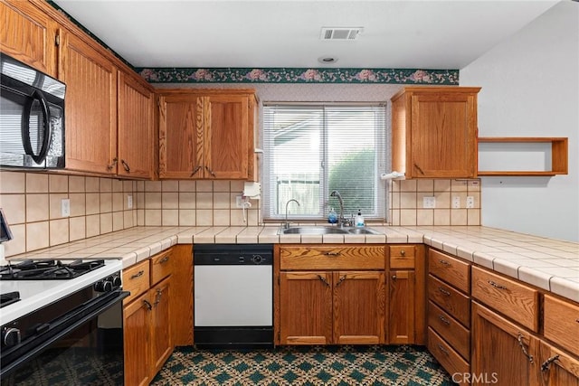 kitchen featuring range with gas cooktop, visible vents, dishwasher, a sink, and black microwave
