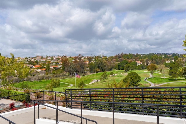 surrounding community with a lawn and golf course view