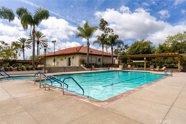 community pool with a patio area