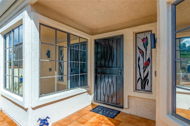 view of exterior entry featuring stucco siding