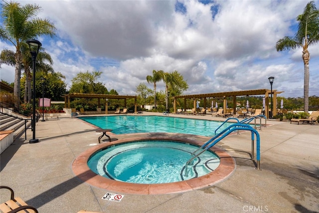 pool with a patio, a hot tub, and a pergola