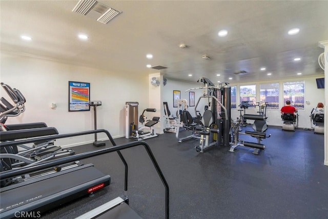 gym with crown molding, recessed lighting, and visible vents
