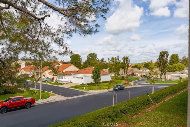 view of road featuring curbs and a residential view