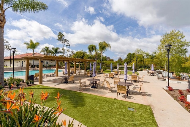 surrounding community featuring a lawn, a pool, and a patio