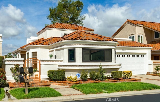 mediterranean / spanish house featuring concrete driveway, stucco siding, a tile roof, and a garage