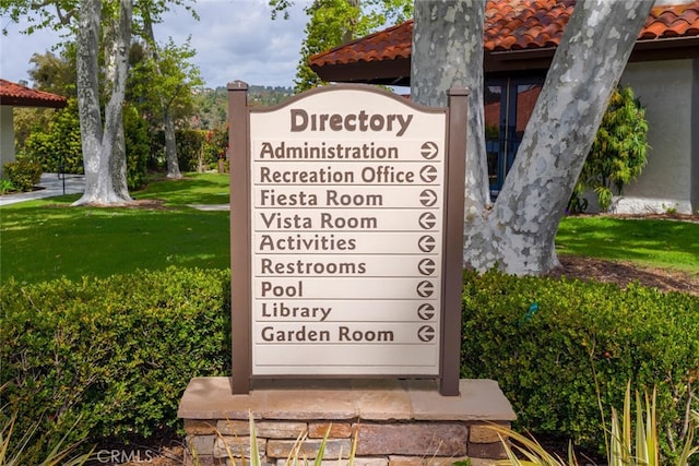 exterior details featuring a tile roof and stucco siding