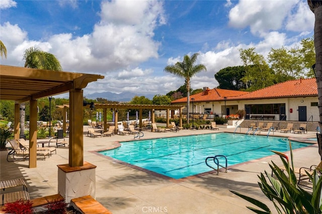 community pool with a patio and a pergola