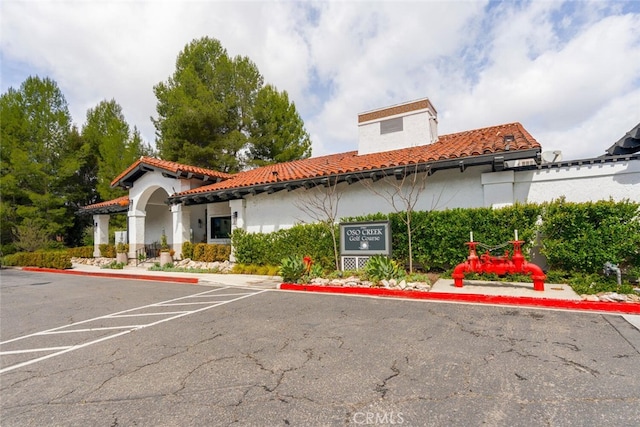 view of building exterior with uncovered parking