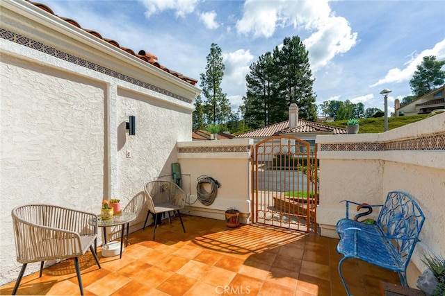 view of patio / terrace featuring fence and a gate