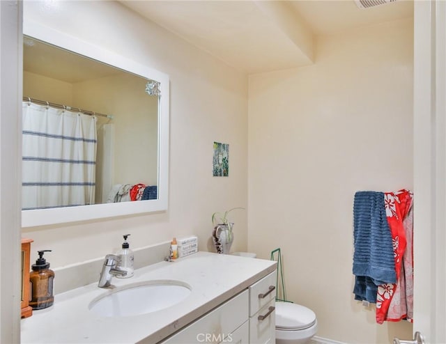 bathroom featuring toilet and vanity