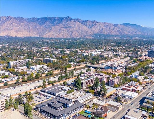 drone / aerial view featuring a city view and a mountain view
