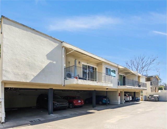 view of building exterior featuring covered parking