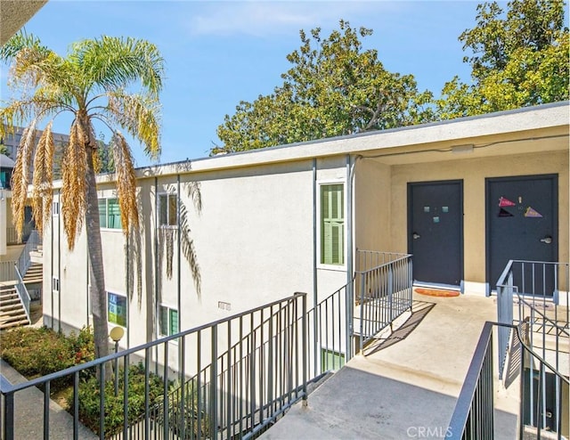 entrance to property featuring stucco siding