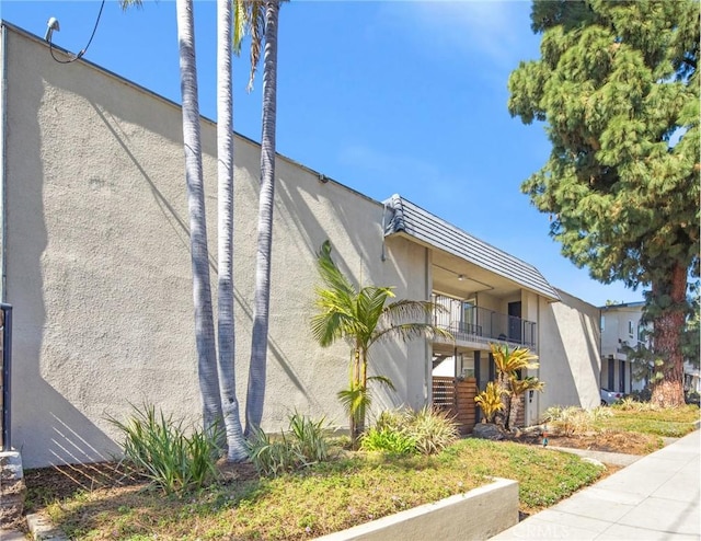 exterior space featuring stairway and stucco siding