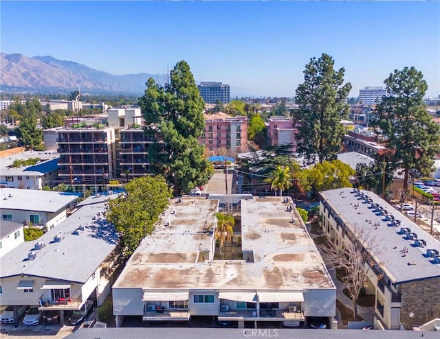 birds eye view of property with a view of city and a mountain view