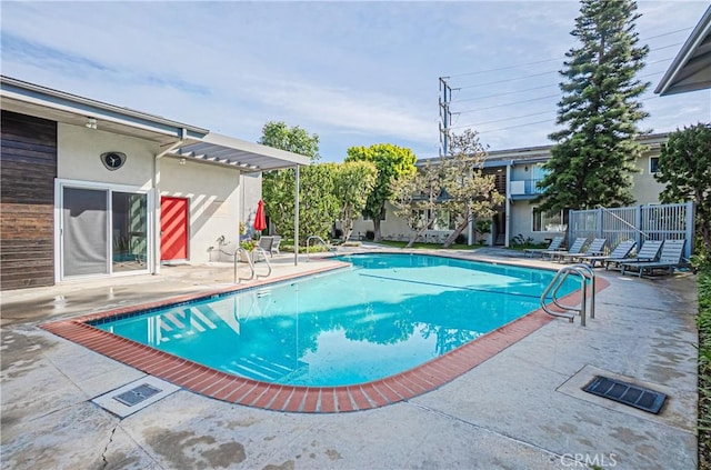 view of swimming pool featuring a fenced in pool, fence, and a patio area