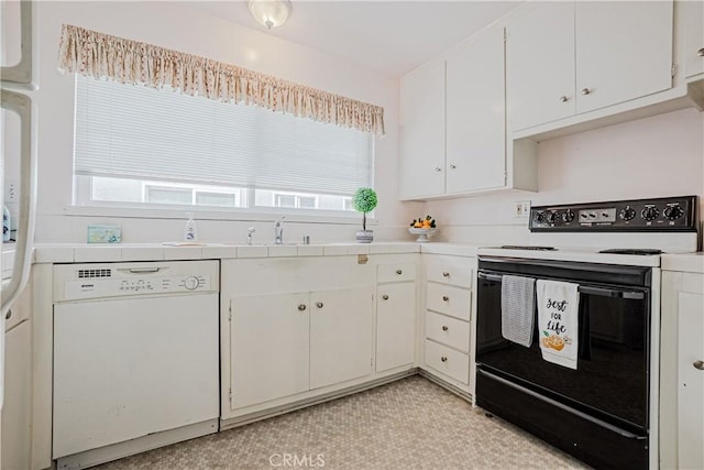 kitchen featuring black electric range, a sink, white cabinets, dishwasher, and tile counters