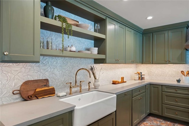 kitchen with green cabinets, open shelves, and a sink