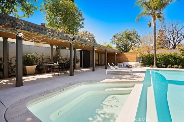 view of swimming pool with a patio and a fenced in pool