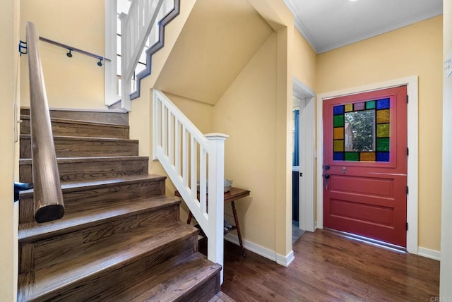 entryway featuring crown molding, dark wood-style floors, stairway, and baseboards