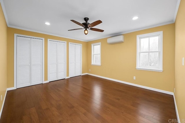 unfurnished room featuring ornamental molding, dark wood-type flooring, ceiling fan, and a wall mounted AC