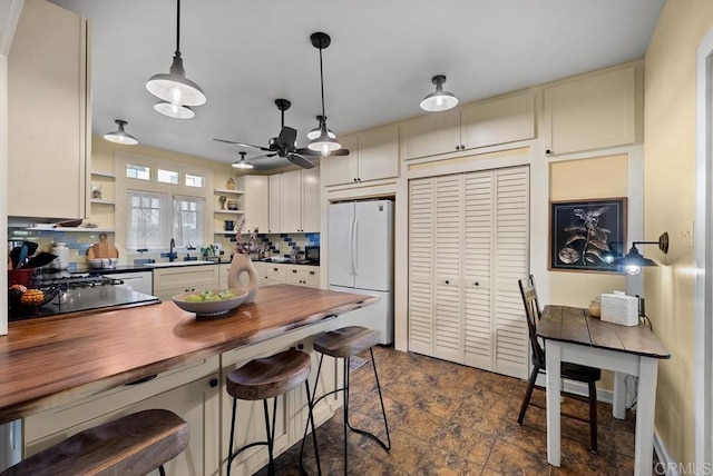 2847 Broadway, San Diego, CA 92102 - kitchen with freestanding refrigerator, open shelves, a ceiling fan, wooden counters, and tasteful backsplash